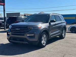 2022 Ford Explorer driving on a scenic road, showcasing its sleek design, spacious interior, and advanced features.