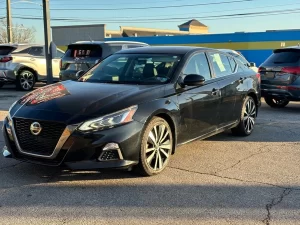 2019 Nissan Altima parked outdoors, highlighting its aerodynamic curves and contemporary styling.