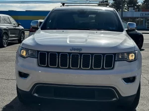 2019 Jeep Grand Cherokee parked on a scenic landscape, showcasing its sleek design and rugged off-road capability.