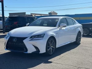 A sleek 2019 Lexus GS 350 sedan parked on a scenic road, showcasing its luxury design and modern features.