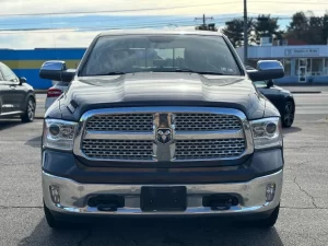 A 2017 RAM 1500 parked on an open road, showcasing its sleek design and rugged durability with a powerful presence.