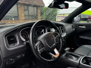 A sleek 2016 Dodge Charger in motion, showcasing its bold design, powerful stance, and modern styling.