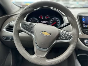 The 2022 Chevrolet Malibu LT parked on a scenic road, showcasing its modern design and stylish exterior details.