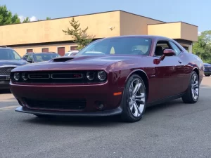 The 2021 Dodge Challenger in a sleek, dynamic pose showcasing its bold design and powerful stance.