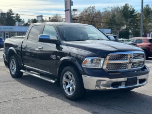 A 2017 RAM 1500 parked on an open road, showcasing its sleek design and rugged durability with a powerful presence.