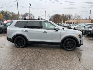 The 2021 Kia Telluride parked outdoors, highlighting its striking exterior design, signature grille, and premium LED headlights.