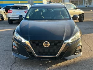 2019 Nissan Altima parked outdoors, highlighting its aerodynamic curves and contemporary styling.