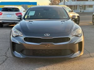 2019 Kia Stinger in a dynamic driving pose, showcasing its sleek design and sporty performance on the open road.