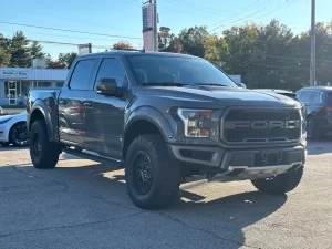 2020 Ford F-150 driving on a rugged road, showcasing its powerful performance and sleek design.