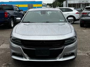 A sleek 2016 Dodge Charger in motion, showcasing its bold design, powerful stance, and modern styling.