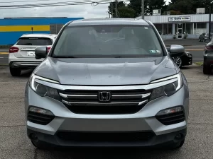 A sleek 2017 Honda Pilot SUV in a neutral setting, showcasing its robust design and spacious family-friendly appeal.