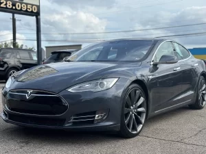 A 2016 Tesla Model S showcasing its sleek, modern design with elegant lines and advanced features, parked in a scenic location.