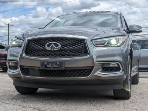 A sleek and stylish 2020 INFINITI QX60 SUV in a sophisticated setting, showcasing its premium design and elegance.