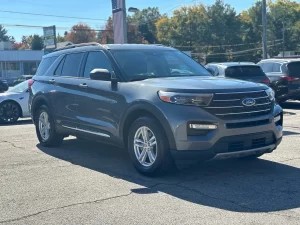 2022 Ford Explorer driving on a scenic road, showcasing its sleek design, spacious interior, and advanced features.