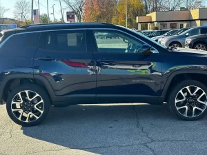 A 2018 Jeep Compass parked on a scenic road, showcasing its sleek design and rugged off-road capabilities.