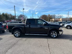 A 2017 RAM 1500 parked on an open road, showcasing its sleek design and rugged durability with a powerful presence.