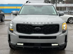 The 2021 Kia Telluride parked outdoors, highlighting its striking exterior design, signature grille, and premium LED headlights.