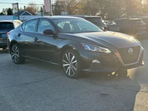 2019 Nissan Altima parked outdoors, highlighting its aerodynamic curves and contemporary styling.