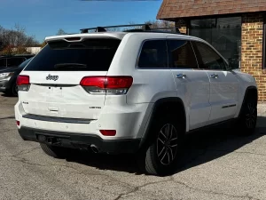 2019 Jeep Grand Cherokee parked on a scenic landscape, showcasing its sleek design and rugged off-road capability.