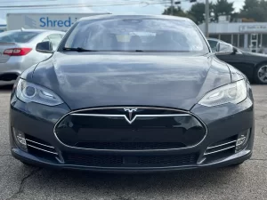 A 2016 Tesla Model S showcasing its sleek, modern design with elegant lines and advanced features, parked in a scenic location.