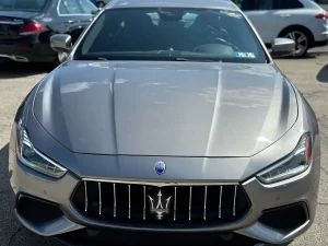 A sleek 2019 Maserati Ghibli SQ4 GranSport in gray, showcasing its elegant design, bold curves, and luxurious appeal against a clean background.