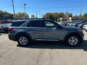 2022 Ford Explorer driving on a scenic road, showcasing its sleek design, spacious interior, and advanced features.