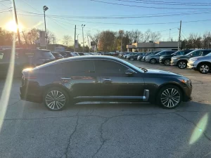 2019 Kia Stinger in a dynamic driving pose, showcasing its sleek design and sporty performance on the open road.