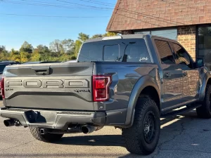 2020 Ford F-150 driving on a rugged road, showcasing its powerful performance and sleek design.