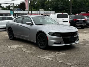 A sleek 2016 Dodge Charger in motion, showcasing its bold design, powerful stance, and modern styling.