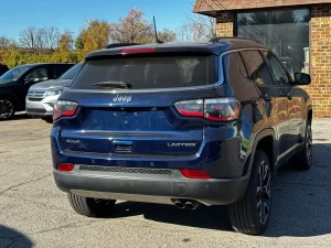 A 2018 Jeep Compass parked on a scenic road, showcasing its sleek design and rugged off-road capabilities.