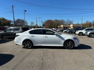 A sleek 2019 Lexus GS 350 sedan parked on a scenic road, showcasing its luxury design and modern features.