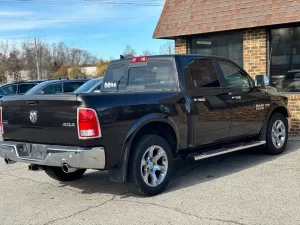 A 2017 RAM 1500 parked on an open road, showcasing its sleek design and rugged durability with a powerful presence.