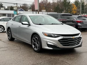 The 2022 Chevrolet Malibu LT parked on a scenic road, showcasing its modern design and stylish exterior details.