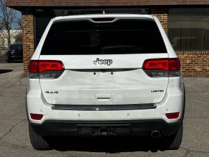 2019 Jeep Grand Cherokee parked on a scenic landscape, showcasing its sleek design and rugged off-road capability.