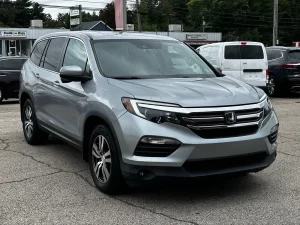 A sleek 2017 Honda Pilot SUV in a neutral setting, showcasing its robust design and spacious family-friendly appeal.