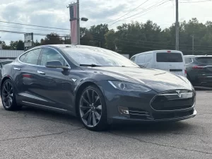 A 2016 Tesla Model S showcasing its sleek, modern design with elegant lines and advanced features, parked in a scenic location.