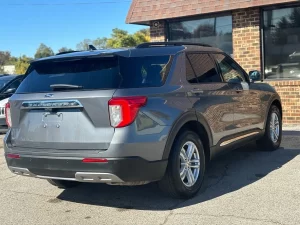 2022 Ford Explorer driving on a scenic road, showcasing its sleek design, spacious interior, and advanced features.