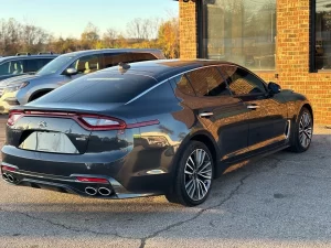 2019 Kia Stinger in a dynamic driving pose, showcasing its sleek design and sporty performance on the open road.