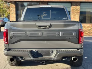 2020 Ford F-150 driving on a rugged road, showcasing its powerful performance and sleek design.