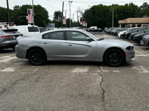 A sleek 2016 Dodge Charger in motion, showcasing its bold design, powerful stance, and modern styling.