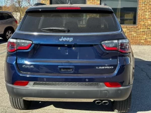 A 2018 Jeep Compass parked on a scenic road, showcasing its sleek design and rugged off-road capabilities.