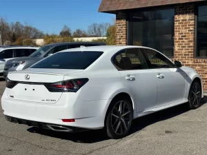 A sleek 2019 Lexus GS 350 sedan parked on a scenic road, showcasing its luxury design and modern features.