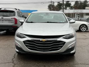 The 2022 Chevrolet Malibu LT parked on a scenic road, showcasing its modern design and stylish exterior details.