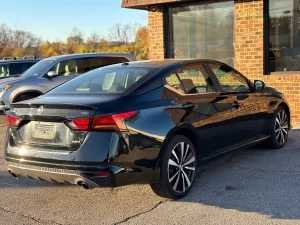 2019 Nissan Altima parked outdoors, highlighting its aerodynamic curves and contemporary styling.