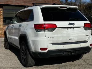 2019 Jeep Grand Cherokee parked on a scenic landscape, showcasing its sleek design and rugged off-road capability.