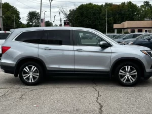 A sleek 2017 Honda Pilot SUV in a neutral setting, showcasing its robust design and spacious family-friendly appeal.