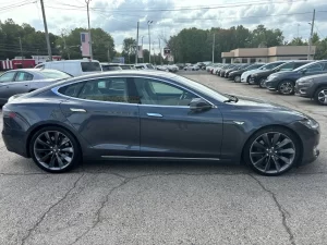 A 2016 Tesla Model S showcasing its sleek, modern design with elegant lines and advanced features, parked in a scenic location.