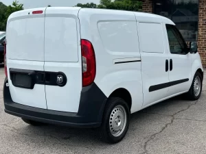 2021 RAM ProMaster City Tradesman parked outdoors, showcasing its sleek design and compact build for versatile business use.