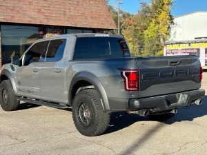 2020 Ford F-150 driving on a rugged road, showcasing its powerful performance and sleek design.