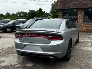 A sleek 2016 Dodge Charger in motion, showcasing its bold design, powerful stance, and modern styling.